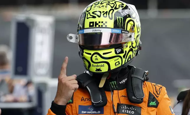 McLaren driver Lando Norris of Britain celebrates after winning the pole position for the Formula 1 Spanish Grand Prix at the Barcelona Catalunya racetrack in Montmelo, near Barcelona, Spain, Saturday, June 22, 2024. The race will be held on Sunday. (AP Photo/Joan Monfort)