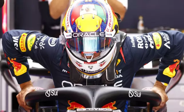 Red Bull driver Sergio Perez of Mexico gets ready in his car during the 2nd practice session for the Formula 1 Spanish Grand Prix at the Barcelona Catalunya racetrack in Montmelo, near Barcelona, Spain, Friday, June 21, 2024. The race will be held on Sunday. (AP Photo/Joan Monfort)