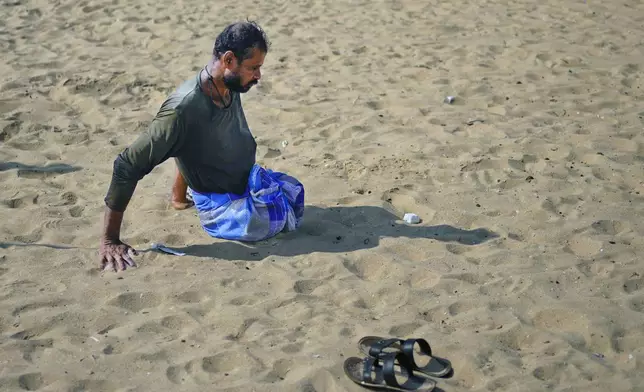 Singaram Soosaimuthu, a 45-year-old former rebel fighter, moves on the beach using his arms as he returns from the sea after fishing overnight, in Mullaitivu, Sri Lanka, May 6, 2023. The former Tamil fighter lost both legs in 2009 as the nation’s generation-long civil war drew to a close and the Tamils retreated in defeat. Sri Lanka's Tamil people still live in the shadow of defeat in the civil war that tore the country apart until it ended 15 years ago. (AP Photo/Eranga Jayawardena)