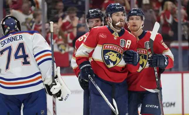 Florida Panthers left wing Matthew Tkachuk (19) reacts after scoring a goal against Edmonton Oilers goaltender Stuart Skinner (74) during the second period of Game 5 of the NHL hockey Stanley Cup Finals, Tuesday, June 18, 2024, in Sunrise, Fla. (AP Photo/Wilfredo Lee)