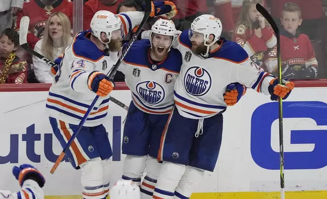Edmonton Oilers center Connor McDavid (97) celebrates his goal during the third period of Game 5 of the NHL hockey Stanley Cup Finals against the Florida Panthers, Tuesday, June 18, 2024, in Sunrise, Fla. The Oilers defeated the Panthers 5-3. (AP Photo/Rebecca Blackwell)