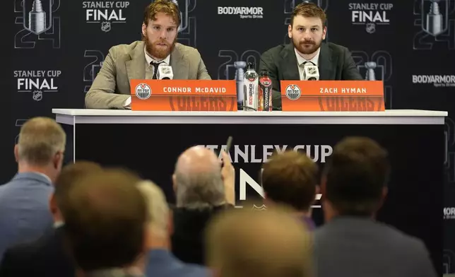 Edmonton Oilers Connor McDaniel and Zach Hyman speak during a news conference following Game 5 of the NHL hockey Stanley Cup Finals against the Florida Panthers, Tuesday, June 18, 2024, in Sunrise, Fla. The Oilers defeated Panthers 5-3. (AP Photo/Rebecca Blackwell)
