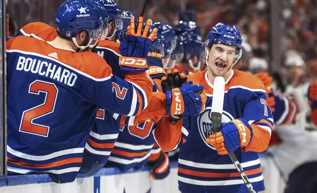 Edmonton Oilers' Ryan McLeod (71) is congratulated for a goal against the Florida Panthers during the third period of Game 6 of the NHL hockey Stanley Cup Final, Friday, June 21, 2024, in Edmonton, Alberta. The Oilers won 5-1 to tie the series. (Jason Franson/The Canadian Press via AP)