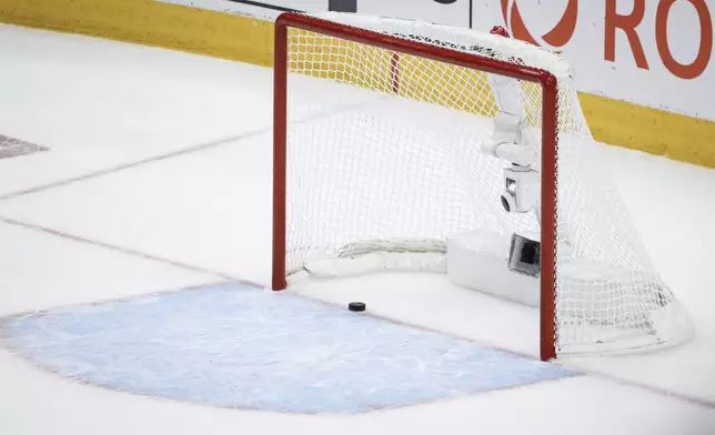 The Edmonton Oilers score an empty-net goal against the Florida Panthers during the third period of Game 6 of the NHL hockey Stanley Cup Final, Friday, June 21, 2024, in Edmonton, Alberta. The Oilers won 5-1 to tie the series. (Jeff McIntosh/The Canadian Press via AP)
