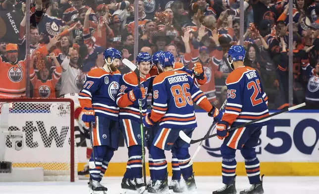 Edmonton Oilers players celebrate an empty-net goal against the Florida Panthers during the third period of Game 6 of the NHL hockey Stanley Cup Final, Friday, June 21, 2024, in Edmonton, Alberta. The Oilers won 5-1 to tie the series. (Jason Franson/The Canadian Press via AP)
