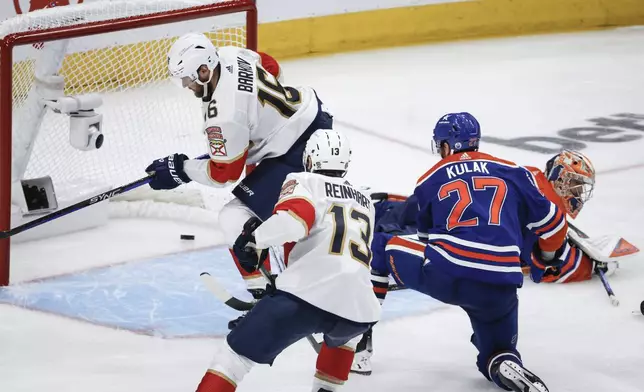 Florida Panthers' Aleksander Barkov (16) scores on Edmonton Oilers goalie Stuart Skinner, right, during the third period of Game 6 of the NHL hockey Stanley Cup Final, Friday, June 21, 2024, in Edmonton, Alberta. The Oilers won 5-1 to tie the series. (Jeff McIntosh/The Canadian Press via AP)