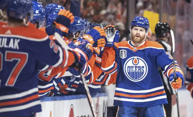 Edmonton Oilers' Warren Foegele (37) is congratulated for a goal against the Florida Panthers during the first period of Game 6 of the NHL hockey Stanley Cup Final, Friday, June 21, 2024, in Edmonton, Alberta. (Jason Franson/The Canadian Press via AP)