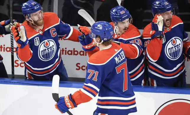 Edmonton Oilers' Ryan McLeod (71) celebrates his goal against the Florida Panthers with teammates during the third period of Game 6 of the NHL hockey Stanley Cup Final, Friday, June 21, 2024, in Edmonton, Alberta. The Oilers won 5-1 to tie the series. (Jeff McIntosh/The Canadian Press via AP)