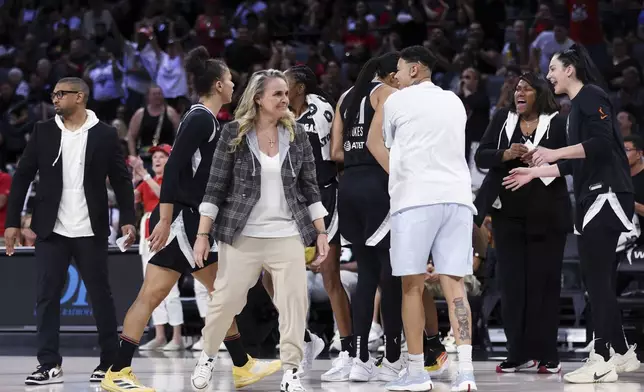 Las Vegas Aces coach Becky Hammon, front left, and players celebrate during a timeout in the first half of a WNBA basketball game against the Seattle Storm on Wednesday, June 19, 2024, in Las Vegas. (Ellen Schmidt/Las Vegas Review-Journal via AP)