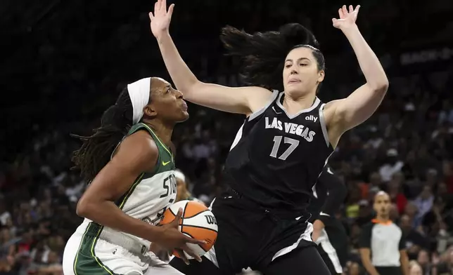 Seattle Storm forward Nneka Ogwumike, left, is defended by Las Vegas Aces center Megan Gustafson (17) during the first half of a WNBA basketball game Wednesday, June 19, 2024, in Las Vegas. (Ellen Schmidt/Las Vegas Review-Journal via AP)