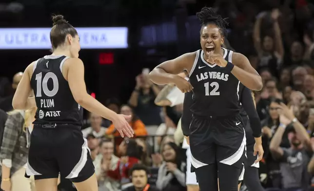 Las Vegas Aces guards Chelsea Gray (12) and Kelsey Plum (10) celebrate a play during the first half of an WNBA basketball game against the Seattle Storm Wednesday, June 19, 2024, in Las Vegas. (Steve Marcus/Las Vegas Sun via AP)
