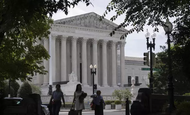 People walk past the Supreme Court on Thursday, June 27, 2024, in Washington. (AP Photo/Mark Schiefelbein)