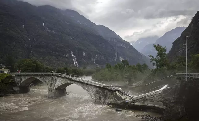 The bridge in Visletteo destroyed due to the storm, in Visletto, in the Maggia Valley, southern Switzerland on Sunday June 30, 2024. The storm in the night from Saturday to Sunday destroyed various traffic routes. Following the landslide in the Maggia Valley, rescuers recovered two bodies on Sunday. One person is still missing, according to the Ticino cantonal police in Valle Maggia. (Michael Buholzer/Keystone via AP)