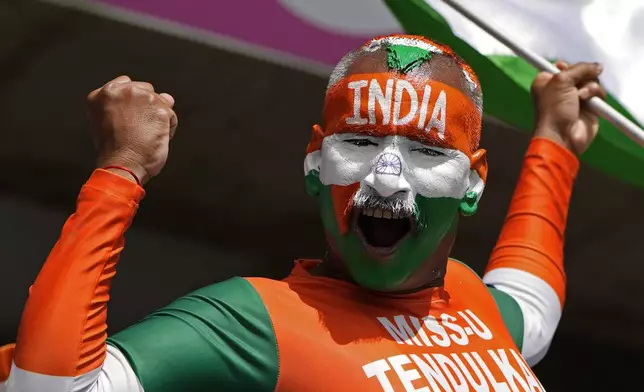 An Indian supporter cheers for his team ahead of the ICC Men's T20 World Cup cricket match between Afghanistan and India at Kensington Oval in Bridgetown, Barbados, Thursday, June 20, 2024. (AP Photo/Ricardo Mazalan)