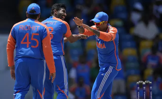 India's Jasprit Bumrah, center, celebrates with teammates after the dismissal of Afghanistan's Hazratullah Zazai during the ICC Men's T20 World Cup cricket match between Afghanistan and India at Kensington Oval in Bridgetown, Barbados, Thursday, June 20, 2024. (AP Photo/Ricardo Mazalan)