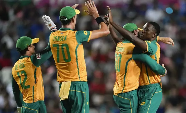 South Africa's Kagiso Rabada, right, is congratulated by teammates after dismissing Afghanistan's Ibrahim Zadran during the men's T20 World Cup semifinal cricket match between Afghanistan and South Africa at the Brian Lara Cricket Academy in Tarouba, Trinidad and Tabago, Wednesday, June 26, 2024. (AP Photo/Ricardo Mazalan)