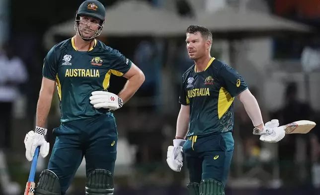 Australia's captain Mitchell Marsh, left, waits for a video review after been given out LBW as teammate David Warner watches during the ICC Men's T20 World Cup cricket match between Australia and Bangladesh in North Sound, Antigua and Barbuda, Thursday, June 20, 2024. (AP Photo/Lynne Sladky)