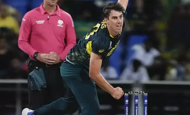Australia's Pat Cummins bowls during the ICC Men's T20 World Cup cricket match between Australia and Bangladesh in North Sound, Antigua and Barbuda, Thursday, June 20, 2024. (AP Photo/Lynne Sladky)