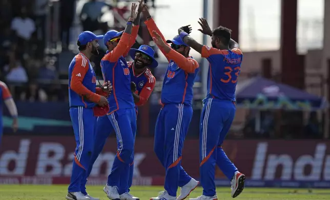 Indian players celebrate during the ICC Men's T20 World Cup second semifinal cricket match between England and India at the Guyana National Stadium in Providence, Guyana, Thursday, June 27, 2024. (AP Photo/Ramon Espinosa)