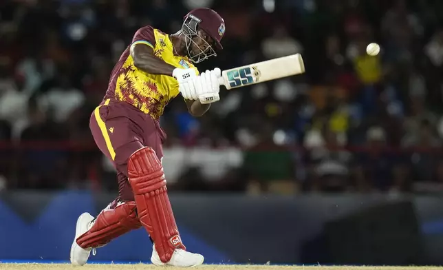 West Indies' Sherfane Rutherford bats during the men's T20 World Cup cricket match between England and the West Indies at Darren Sammy National Cricket Stadium, Gros Islet, St Lucia, Wednesday, June 19, 2024. (AP Photo/Ramon Espinosa)