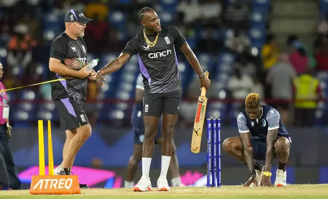England's Jofra Archer, centre, warms up ahead of the men's T20 World Cup cricket match between England and the West Indies at Darren Sammy National Cricket Stadium, Gros Islet, St Lucia, Wednesday, June 19, 2024. (AP Photo/Ramon Espinosa)