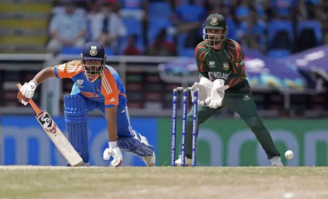 India's Rishabh Pant, left, reacts after playing a shot during the ICC Men's T20 World Cup cricket match between India and Bangladesh at Sir Vivian Richards Stadium in North Sound, Antigua and Barbuda, Saturday, June 22, 2024. (AP Photo/Lynne Sladky)