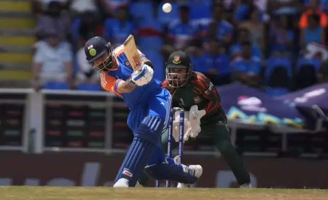 India's Virat Kohli hits a six during the ICC Men's T20 World Cup cricket match between India and Bangladesh at Sir Vivian Richards Stadium in North Sound, Antigua and Barbuda, Saturday, June 22, 2024. (AP Photo/Lynne Sladky)