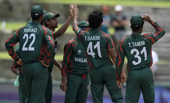 Bangladesh's Tanzim Hasan, second right, celebrates with teammates after the dismissal of India's Virat Kohli during the ICC Men's T20 World Cup cricket match between India and Bangladesh at Sir Vivian Richards Stadium in North Sound, Antigua and Barbuda, Saturday, June 22, 2024. (AP Photo/Lynne Sladky)