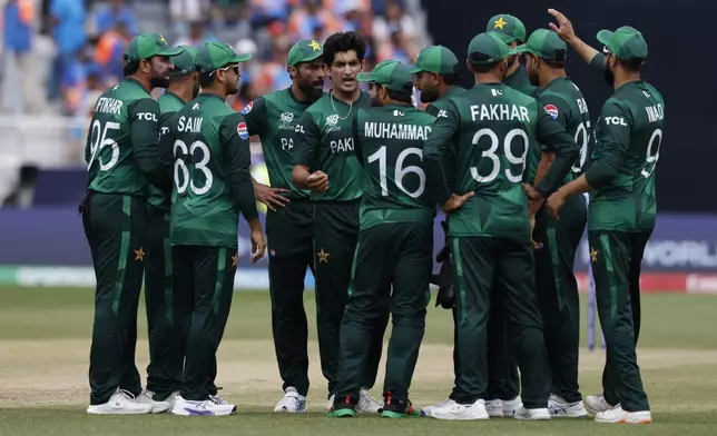 Pakistan's Naseem Shah, center without cap, celebrates with teammates after the dismissal of India's Axar Patel during the ICC Men's T20 World Cup cricket match between India and Pakistan at the Nassau County International Cricket Stadium in Westbury, New York, Sunday, June 9, 2024. (AP Photo/Eduardo Munoz)