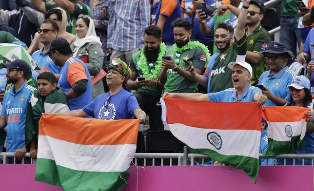 Fans cheer for their teams prior to the start of the ICC Men's T20 World Cup cricket match between India and Pakistan at the Nassau County International Cricket Stadium in Westbury, New York, Sunday, June 9, 2024. (AP Photo/Adam Hunger)