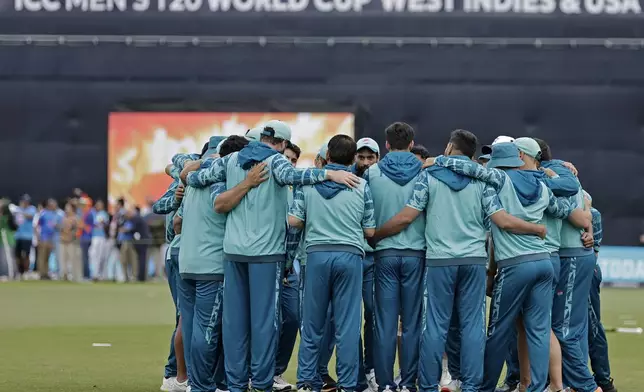 Pakistan players stand in a huddle prior to the start of the ICC Men's T20 World Cup cricket match between India and Pakistan at the Nassau County International Cricket Stadium in Westbury, New York, Sunday, June 9, 2024. (AP Photo/Adam Hunger)