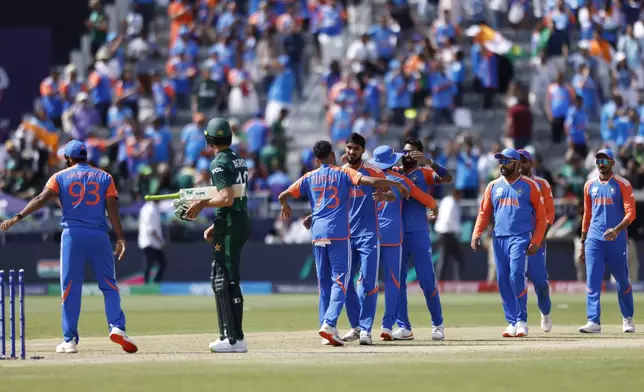 Indian players celebrate after their win in the ICC Men's T20 World Cup cricket match between India and Pakistan at the Nassau County International Cricket Stadium in Westbury, New York, Sunday, June 9, 2024. (AP Photo/Eduardo Munoz)