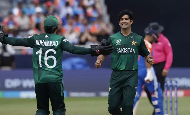 Pakistan's Naseem Shah, right, celebrates with teammate Mohammad Rizwan after the dismissal of India's Axar Patel during the ICC Men's T20 World Cup cricket match between India and Pakistan at the Nassau County International Cricket Stadium in Westbury, New York, Sunday, June 9, 2024. (AP Photo/Eduardo Munoz)