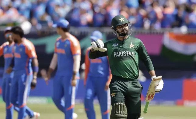 Pakistan's Shadab Khan reacts as he walks off the field after losing his wicket during the ICC Men's T20 World Cup cricket match between India and Pakistan at the Nassau County International Cricket Stadium in Westbury, New York, Sunday, June 9, 2024. (AP Photo/Adam Hunger)