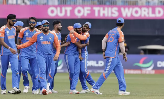 Indian players celebrate the dismissal of Pakistan's Iftikhar Ahmed during the ICC Men's T20 World Cup cricket match between India and Pakistan at the Nassau County International Cricket Stadium in Westbury, New York, Sunday, June 9, 2024. (AP Photo/Adam Hunger)