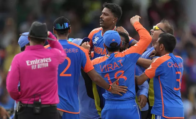 India's Hardik Pandya, center, and teammates celebrate after their win against South Africa in the ICC Men's T20 World Cup final cricket match at Kensington Oval in Bridgetown, Barbados, Saturday, June 29, 2024. (AP Photo/Ricardo Mazalan)