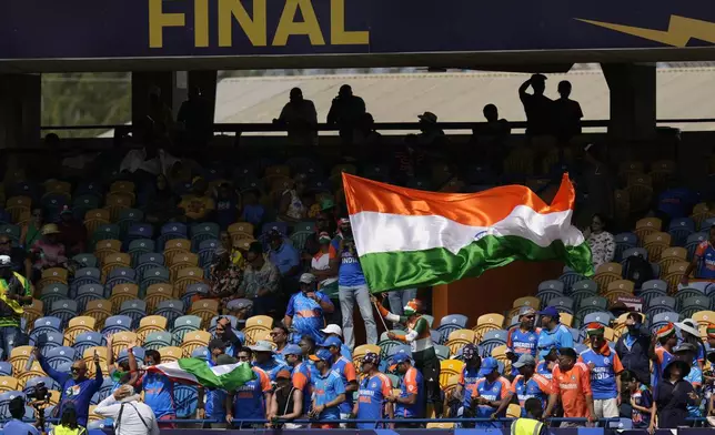 Indian fans cheer for their team before the ICC Men's T20 World Cup final cricket match between India and South Africa at Kensington Oval in Bridgetown, Barbados, Saturday, June 29, 2024. (AP Photo/Ramon Espinosa)