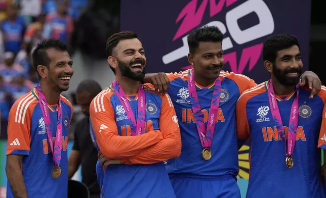 India's Virat Kohli, second left, shares a laugh with teammates at the presentation ceremony after defeating South Africa in the ICC Men's T20 World Cup final cricket match at Kensington Oval in Bridgetown, Barbados, Saturday, June 29, 2024. (AP Photo/Ricardo Mazalan)
