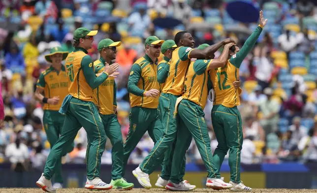 South Africa's Quinton de Kock, right, celebrates with teammates the wicket of India's Axar Patel during the ICC Men's T20 World Cup final cricket match between India and South Africa at Kensington Oval in Bridgetown, Barbados, Saturday, June 29, 2024. (AP Photo/Ramon Espinosa)