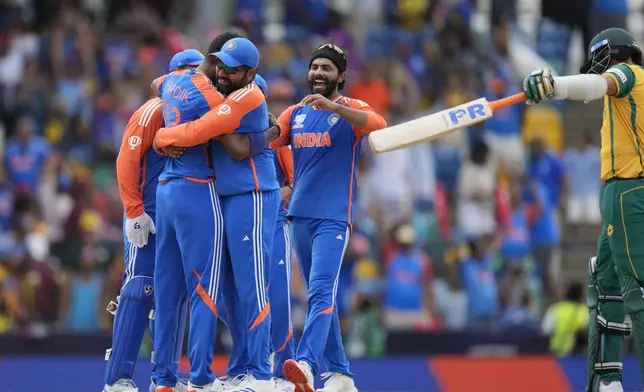 India's Hardik Pandya, second left, celebrates with teammates after the dismissal of South Africa's Kagiso Rabada during the ICC Men's T20 World Cup final cricket match between India and South Africa at Kensington Oval in Bridgetown, Barbados, Saturday, June 29, 2024. (AP Photo/Ricardo Mazalan)