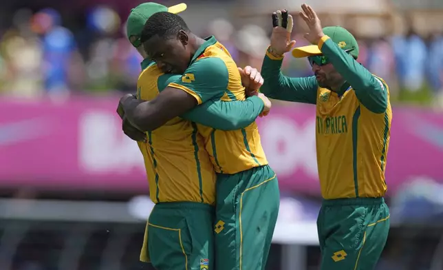 South Africa's Kagiso Rabada, center, celebrates with teammates after the dismissal of India's Suryakumar Yadav during the ICC Men's T20 World Cup final cricket match between India and South Africa at Kensington Oval in Bridgetown, Barbados, Saturday, June 29, 2024. (AP Photo/Ricardo Mazalan)