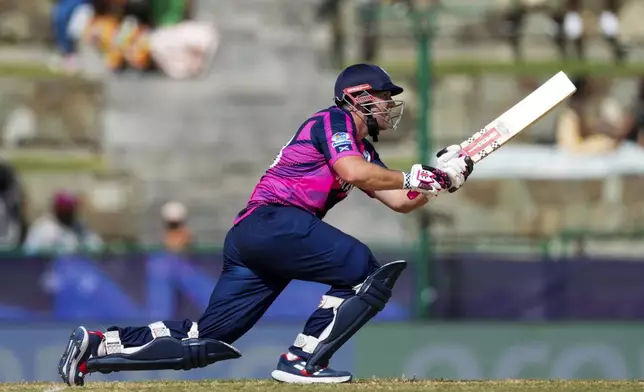 Scotland's George Munsey plays a shot for four runs against Oman during an ICC Men's T20 World Cup cricket match at Sir Vivian Richards Stadium in North Sound, Antigua and Barbuda, Sunday, June 9, 2024. (AP Photo/Ricardo Mazalan)