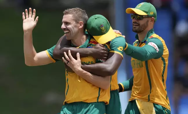South Africa's Anrich Nortje, left, celebrates with teammates after the dismissal of United States' Corey Anderson during the ICC Men's T20 World Cup cricket match between the United States and South Africa at Sir Vivian Richards Stadium in North Sound, Antigua and Barbuda, Wednesday, June 19, 2024. (AP Photo/Ricardo Mazalan)