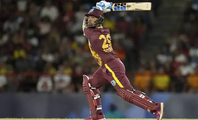 West Indies' Nicholas Pooran hits six against Afghanistan during an ICC Men's T20 World Cup cricket match at Daren Sammy National Cricket Stadium in Gros Islet, Saint Lucia, Monday, June 17, 2024. (AP Photo/Ramon Espinosa)