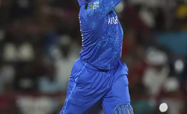 Afghanistan's Azmatullah Omarzai hit a six against West Indies during an ICC Men's T20 World Cup cricket match at Daren Sammy National Cricket Stadium in Gros Islet, Saint Lucia, Monday, June 17, 2024. (AP Photo/Ramon Espinosa)