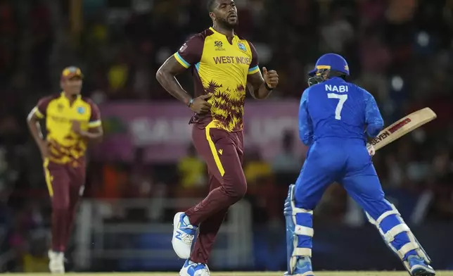 West Indies' Obed McCoy celebrates after he bowled out Afghanistan's Mohammad Nabi during an ICC Men's T20 World Cup cricket match at Daren Sammy National Cricket Stadium in Gros Islet, Saint Lucia, Monday, June 17, 2024. (AP Photo/Ramon Espinosa)