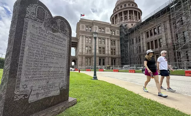 Visitors walk past a monument of the Ten Commandments outside the Capitol, Thursday, June 20, 2024, in Austin, Texas. (AP Photo/Paul Weber)