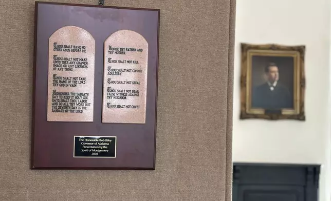 A copy of the Ten Commandments hangs in the Alabama Capitol in Montgomery, Ala., Thursday, June 20, 2024. The wooden plaque hangs next to a display titled "The Foundation of Our Law" that also includes information about the Magna Carta and the Mayflower Compact. The display sits in a room that housed the Alabama Supreme Court library between 1885 and 1940 and is now used for historical displays. (AP Photo/Kim Chandler)