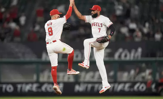 Los Angeles Angels shortstop Zach Neto, left, and right fielder Jo Adell celebrate the team's win in a baseball game against the Detroit Tigers, Thursday, June 27, 2024, in Anaheim, Calif. (AP Photo/Ryan Sun)