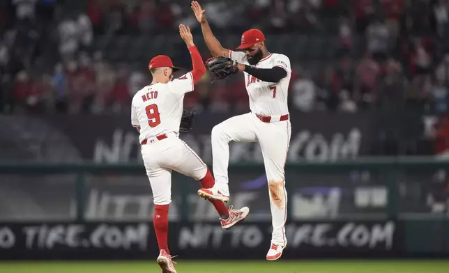 Los Angeles Angels shortstop Zach Neto, left, and right fielder Jo Adell celebrate the team's win in a baseball game against the Detroit Tigers, Friday, June 28, 2024, in Anaheim, Calif. (AP Photo/Ryan Sun)